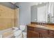 This bathroom features a shower-tub combination, tiled walls, and a vanity with lots of counter space at 17301 Ladera Estates Blvd, Lutz, FL 33548