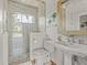 Bathroom featuring tiled shower, pedestal sink, and brushed metal fixtures at 17301 Ladera Estates Blvd, Lutz, FL 33548