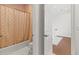 Bathroom showing the tub and toilet area, with access to another room visible through an open door at 17301 Ladera Estates Blvd, Lutz, FL 33548
