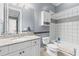 Bathroom featuring white cabinets, granite countertops, neutral tile floors, and a tub-shower combo at 17301 Ladera Estates Blvd, Lutz, FL 33548