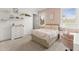 Relaxing bedroom with plush carpet, a comfortable bed, a desk, and plenty of storage at 17301 Ladera Estates Blvd, Lutz, FL 33548