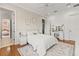 Bedroom featuring white walls, wood floors, white bedding, a vanity table, and decor at 17301 Ladera Estates Blvd, Lutz, FL 33548