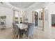 Elegant dining room features a modern chandelier, large windows and stylish gray upholstered chairs at 17301 Ladera Estates Blvd, Lutz, FL 33548