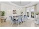 Bright dining room featuring a modern chandelier, and ten comfortable gray upholstered chairs at 17301 Ladera Estates Blvd, Lutz, FL 33548