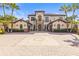 Beautiful two-story home with a brick driveway, mature palm trees, and an inviting entrance with stone accents at 17301 Ladera Estates Blvd, Lutz, FL 33548