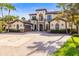 Stately home with stone accents, manicured landscaping, and brick paver driveway at 17301 Ladera Estates Blvd, Lutz, FL 33548