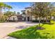 Elegant two-story home with a tile roof, paver driveway, and mature landscaping at 17301 Ladera Estates Blvd, Lutz, FL 33548
