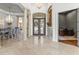 Elegant foyer with marble floors, decorative columns, and a view of the dining area and study at 17301 Ladera Estates Blvd, Lutz, FL 33548