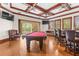 This opulent game room is equipped with bar, seating, and outdoor fireplace access at 17301 Ladera Estates Blvd, Lutz, FL 33548