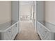 Hallway view showcases dual white cabinets and opens to a carpeted living area at 17301 Ladera Estates Blvd, Lutz, FL 33548