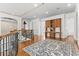 Spacious hallway with hardwood floors, built-in desk and cabinetry, decorative rug, and wrought iron railing at 17301 Ladera Estates Blvd, Lutz, FL 33548