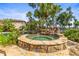 Stone hot tub with waterfall feature and lush landscaping at 17301 Ladera Estates Blvd, Lutz, FL 33548