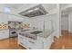 This gourmet kitchen features a large island with a cooktop and modern stainless steel appliances at 17301 Ladera Estates Blvd, Lutz, FL 33548