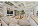 Bright living room with detailed coffered ceiling, fireplace, and comfortable seating at 17301 Ladera Estates Blvd, Lutz, FL 33548