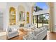 Bright and airy living room featuring a stone fireplace, high ceilings, and an outdoor view at 17301 Ladera Estates Blvd, Lutz, FL 33548