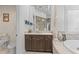 Vanity in the main bathroom boasts a marble countertop, cabinets, and a large mirror at 17301 Ladera Estates Blvd, Lutz, FL 33548