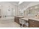 Main bathroom with double sink vanity, a make-up station, a soaking tub, and a shower at 17301 Ladera Estates Blvd, Lutz, FL 33548
