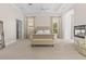 Spacious main bedroom featuring high tray ceilings, a fireplace, and ensuite bathroom at 17301 Ladera Estates Blvd, Lutz, FL 33548