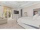 Bright main bedroom features a ceiling fan, TV, sitting area, and private outdoor access at 17301 Ladera Estates Blvd, Lutz, FL 33548