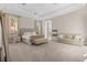 Large main bedroom featuring tray ceilings, sitting area with fireplace, and lots of natural light at 17301 Ladera Estates Blvd, Lutz, FL 33548