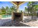 Inviting outdoor living space features a covered fireplace, spiral staircase, and views of the pool at 17301 Ladera Estates Blvd, Lutz, FL 33548