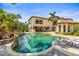 Backyard pool featuring a stone waterfall and multiple patio areas at 17301 Ladera Estates Blvd, Lutz, FL 33548