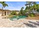 Sparkling pool with swim-up seating and brick paver surround at 17301 Ladera Estates Blvd, Lutz, FL 33548