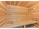 Relaxing wooden sauna room with built-in benches and traditional design at 17301 Ladera Estates Blvd, Lutz, FL 33548