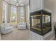 Sitting room with large bay windows, bright natural light, fireplace, and comfortable furniture at 17301 Ladera Estates Blvd, Lutz, FL 33548