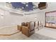 A state-of-the-art theater room boasts premium seating under a custom ceiling with cloud accents at 17301 Ladera Estates Blvd, Lutz, FL 33548