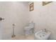 Toilet room features a luxurious commode, bidet, and a hand-painted textured wall at 17301 Ladera Estates Blvd, Lutz, FL 33548