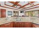 The wet bar features granite countertops, wood cabinets, and great view of the backyard at 17301 Ladera Estates Blvd, Lutz, FL 33548
