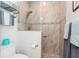 Updated bathroom featuring a tiled shower with a mosaic accent and neutral paint at 180 Rotonda N Blvd, Rotonda West, FL 33947