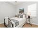 Comfortable bedroom with a metal frame bed, side table, and a walk-in closet at 180 Rotonda N Blvd, Rotonda West, FL 33947