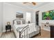 Comfortable bedroom with a metal frame bed, side table, and a walk-in closet at 180 Rotonda N Blvd, Rotonda West, FL 33947