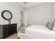 Comfortable bedroom with a metal frame bed, dresser, and walk-in closet at 180 Rotonda N Blvd, Rotonda West, FL 33947