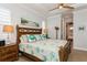 Comfortable main bedroom with beach-themed decor, wood furniture, and a ceiling fan at 180 Rotonda N Blvd, Rotonda West, FL 33947