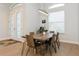 Bright dining area features wood table, contemporary lighting, and ample natural light at 180 Rotonda N Blvd, Rotonda West, FL 33947