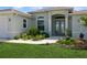 Beautiful front entrance with decorative glass doors, manicured flower beds and archway at 180 Rotonda N Blvd, Rotonda West, FL 33947