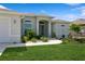 Beautiful front entrance with decorative glass doors, manicured flower beds and palm trees at 180 Rotonda N Blvd, Rotonda West, FL 33947