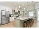 Spacious kitchen featuring a large center island with seating, modern appliances, and white cabinetry at 180 Rotonda N Blvd, Rotonda West, FL 33947