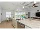 Open-concept kitchen with an island, modern appliances, and sliding glass doors to the patio at 180 Rotonda N Blvd, Rotonda West, FL 33947