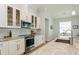 Well-lit kitchen with stainless steel appliances, marble countertops, and modern cabinets at 180 Rotonda N Blvd, Rotonda West, FL 33947