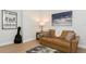 Modern living room features leather sofa and stylish decor for a relaxing atmosphere at 180 Rotonda N Blvd, Rotonda West, FL 33947