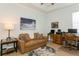 Cozy living room features leather sofa, decorative art and office furniture at 180 Rotonda N Blvd, Rotonda West, FL 33947