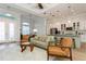 Open concept living room and kitchen with modern decor, and pendant lighting at 180 Rotonda N Blvd, Rotonda West, FL 33947