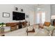 Living room with a decorative glass front door, tv mounted on the wall, and modern furniture at 180 Rotonda N Blvd, Rotonda West, FL 33947