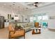 Open concept living room and kitchen area with modern decor, ceiling fan, and pendant lighting at 180 Rotonda N Blvd, Rotonda West, FL 33947