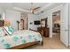 Well-lit main bedroom with wood furniture and ensuite bathroom entrance at 180 Rotonda N Blvd, Rotonda West, FL 33947