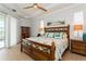 Bright main bedroom boasts tray ceilings, wood furniture, and access to outdoor pool area at 180 Rotonda N Blvd, Rotonda West, FL 33947